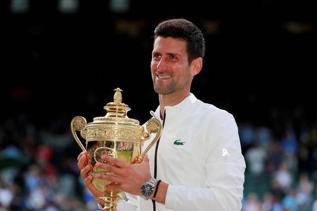 Djokovic poses with the trophy