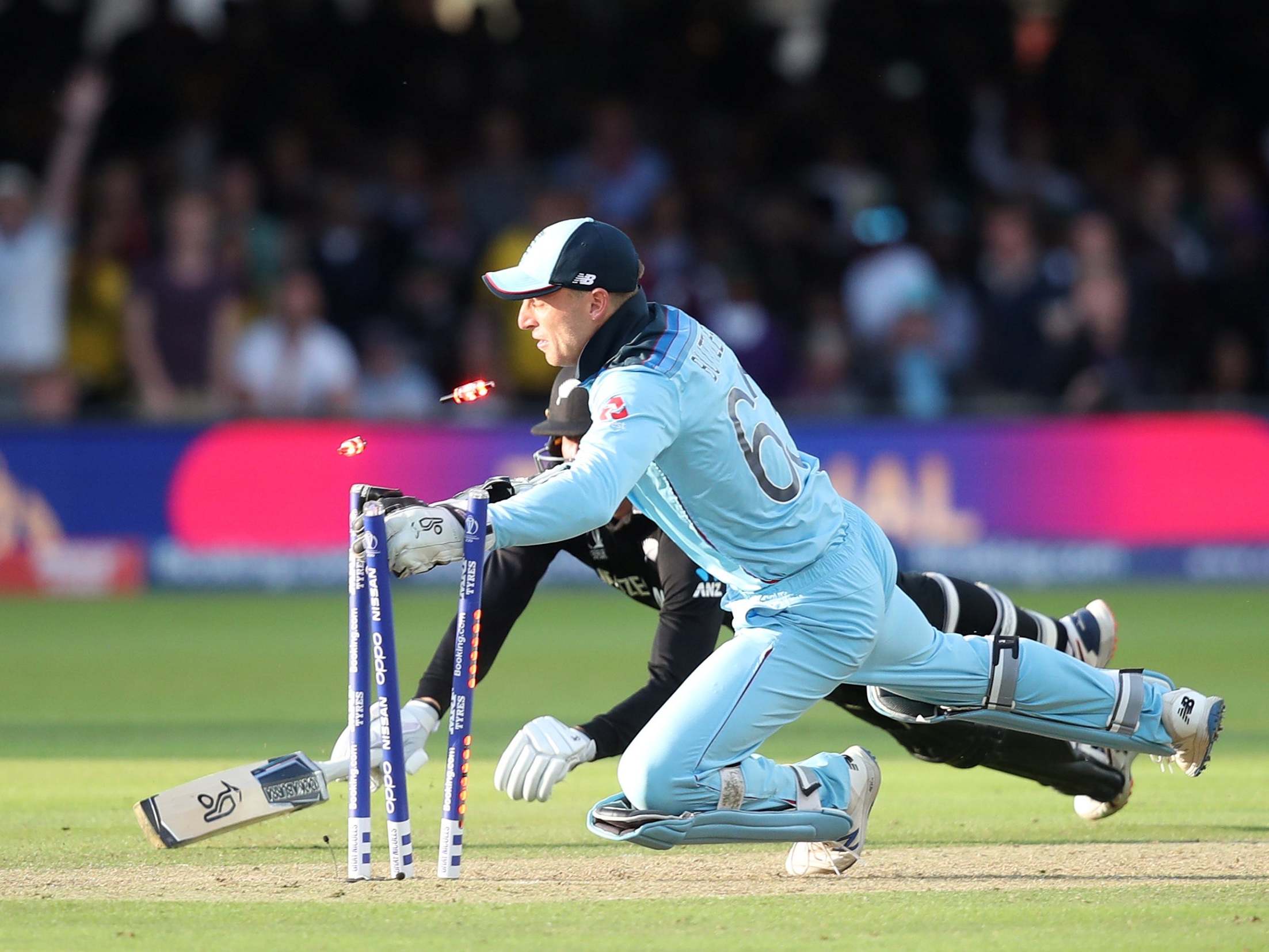 Jos Buttler sweeps away the bails to win the World Cup