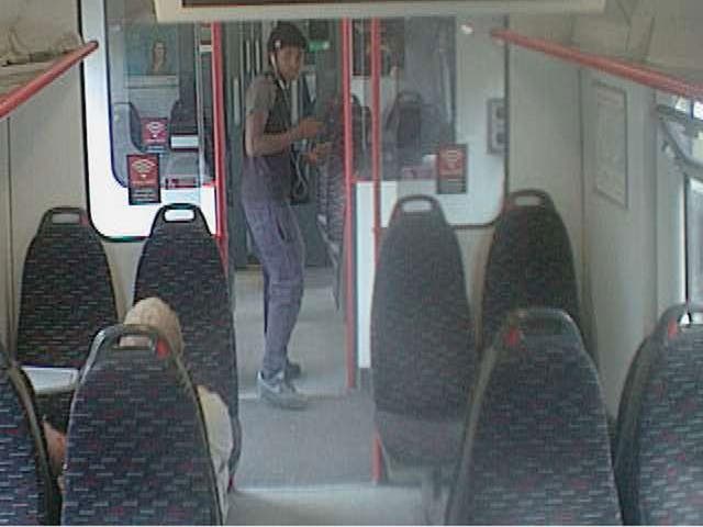 A CCTV image of the man British Transport Police want to trace in connection with the armed mugging