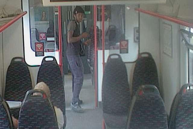 A CCTV image of the man British Transport Police want to trace in connection with the armed mugging