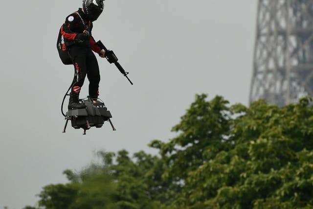 Zapata CEO Franky Zapata flies a jet-powered hoverboard or 'Flyboard prior to the Bastille Day military parade down the Champs-Elysees avenue in Paris on 14 July, 2019