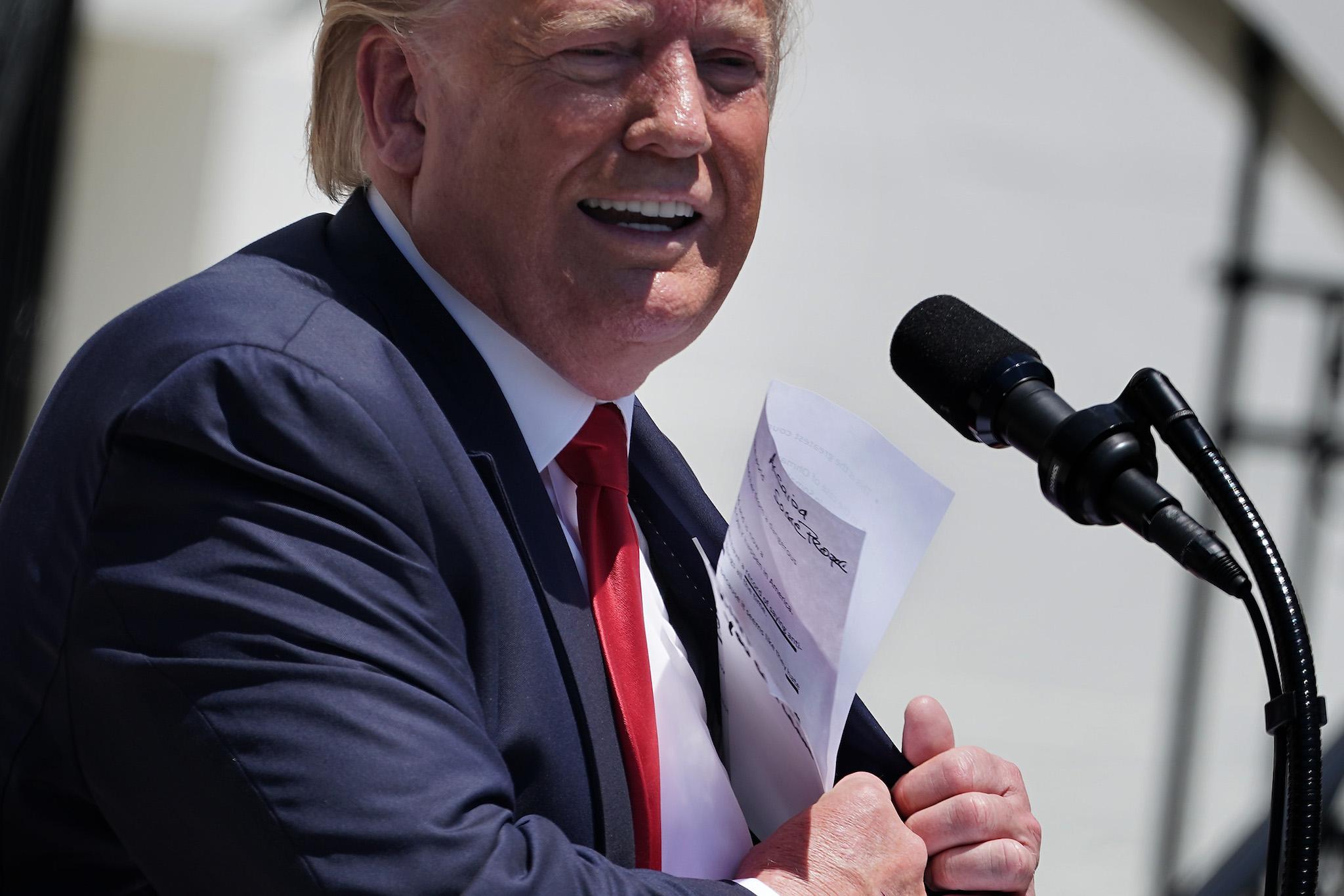 U.S. President Donald Trump puts away his notes after addressing his Made In America product showcase at the White House July 15, 2019 in Washington, DC
