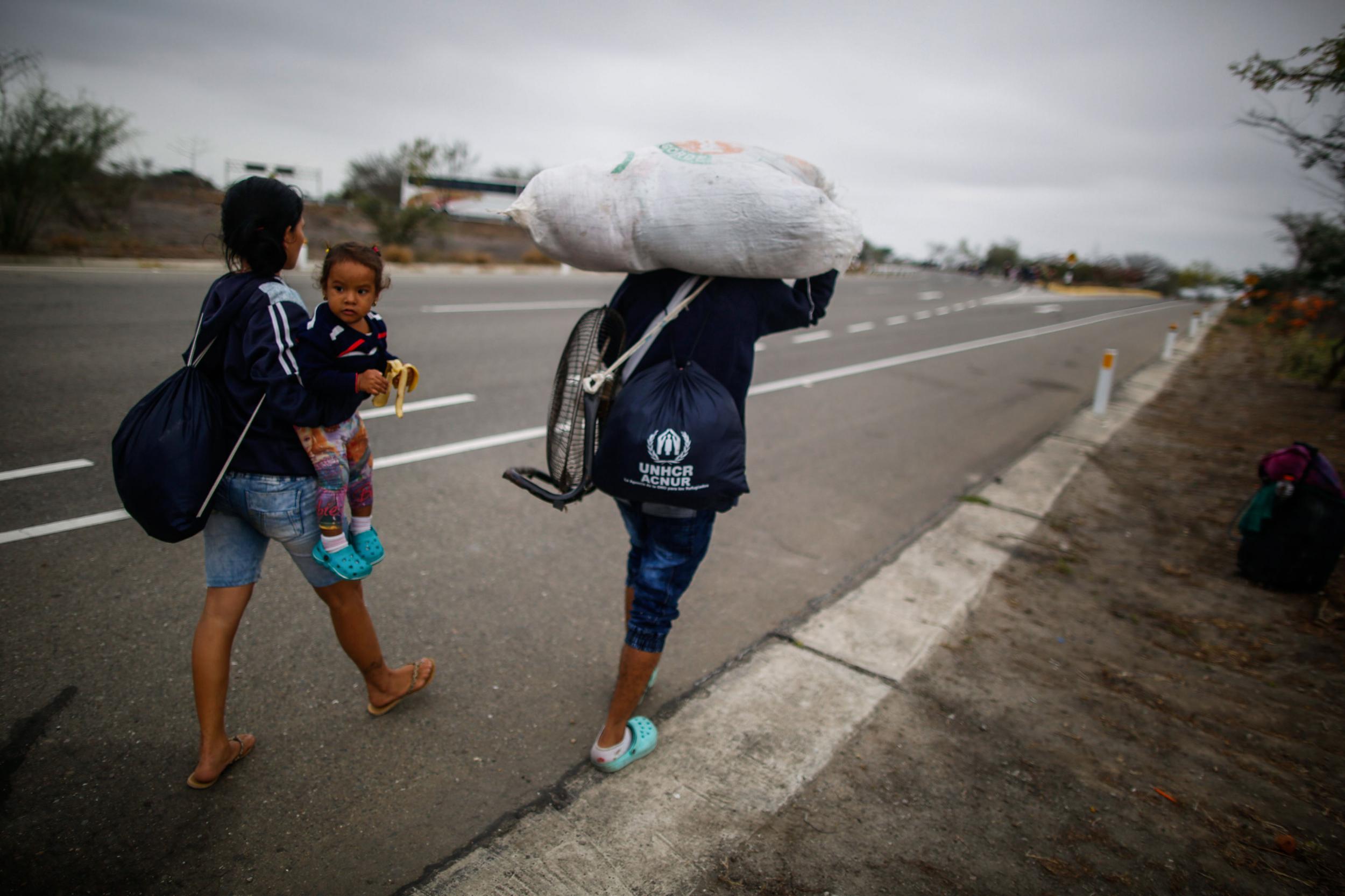 Venezuelan migrants set off on foot after leaving border care centre facilities in Tumbes, Peru (AFP)
