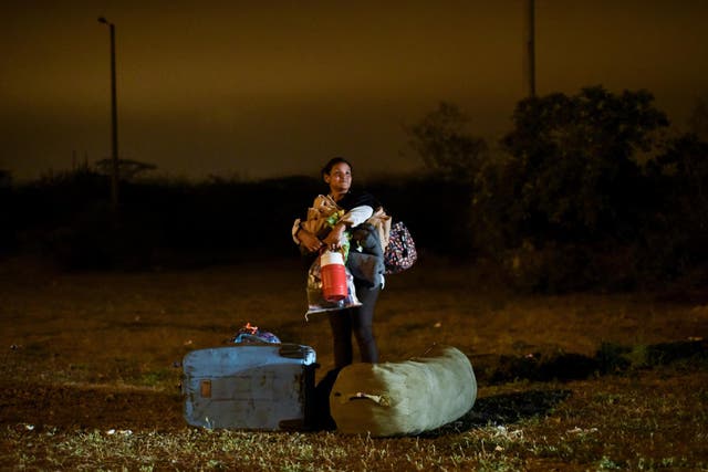 A Venezuelan migrant crosses the border between Ecuador and Peru