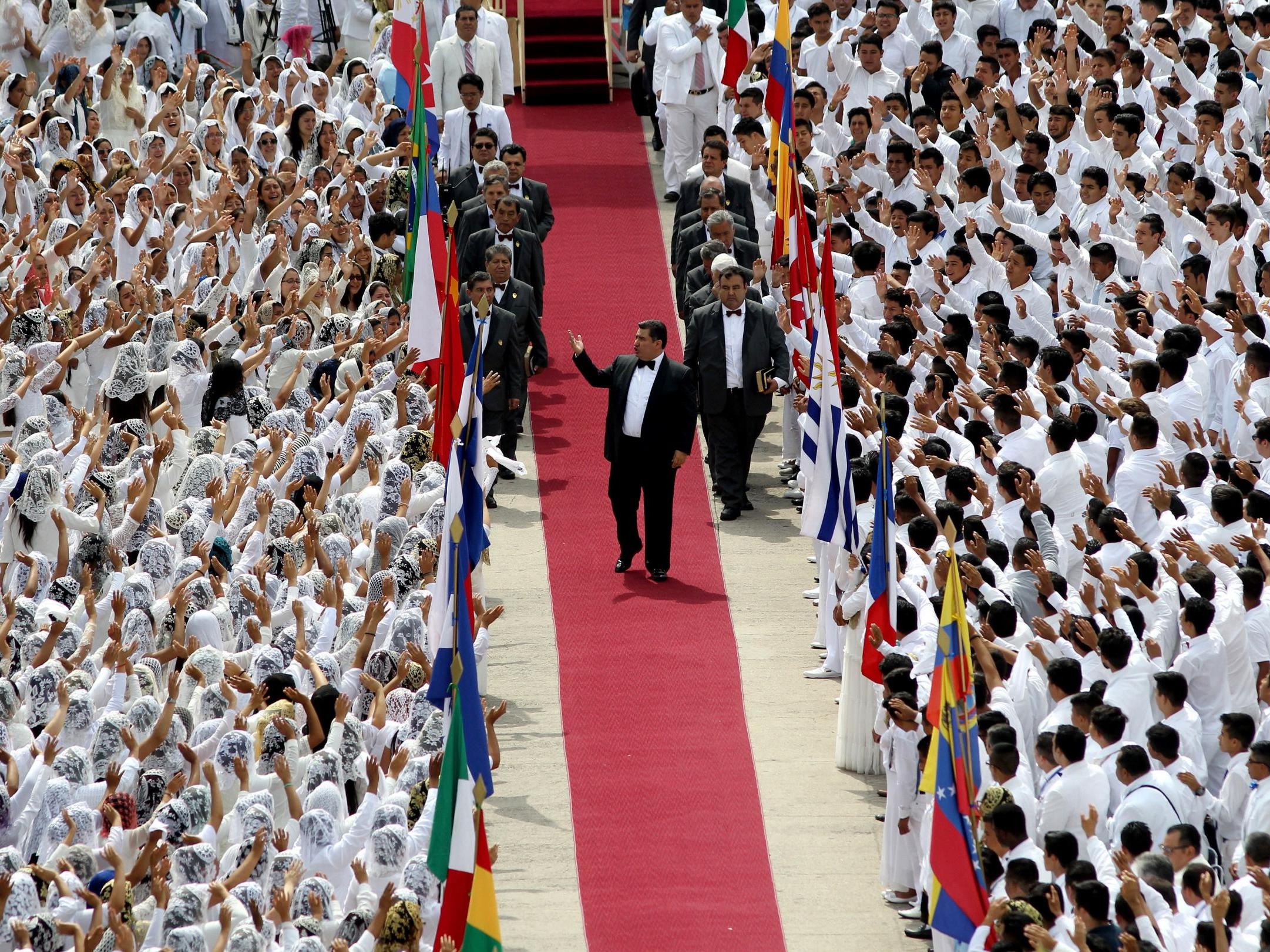 The leader of the Church of the Light of the World, Naason Joaquin Garcia, walks among his parishioners during the annual Holy Convocation at the church's headquarters in Guadalajara, Mexico, 2018