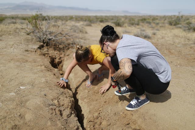 Ridgecrest residents inspect the rupture following two large earthquakes in the area on 7 July