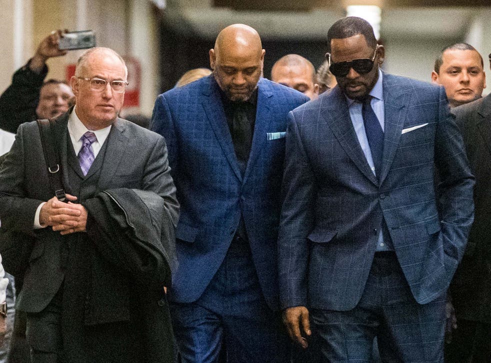 Attorney Steve Greenberg, left, walks with singer R Kelly, right, at a previous court hearing in Chicago
