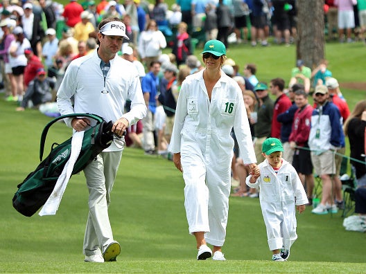 Bubba Watson walks with his wife, Angie, and son, Caleb at Augusta