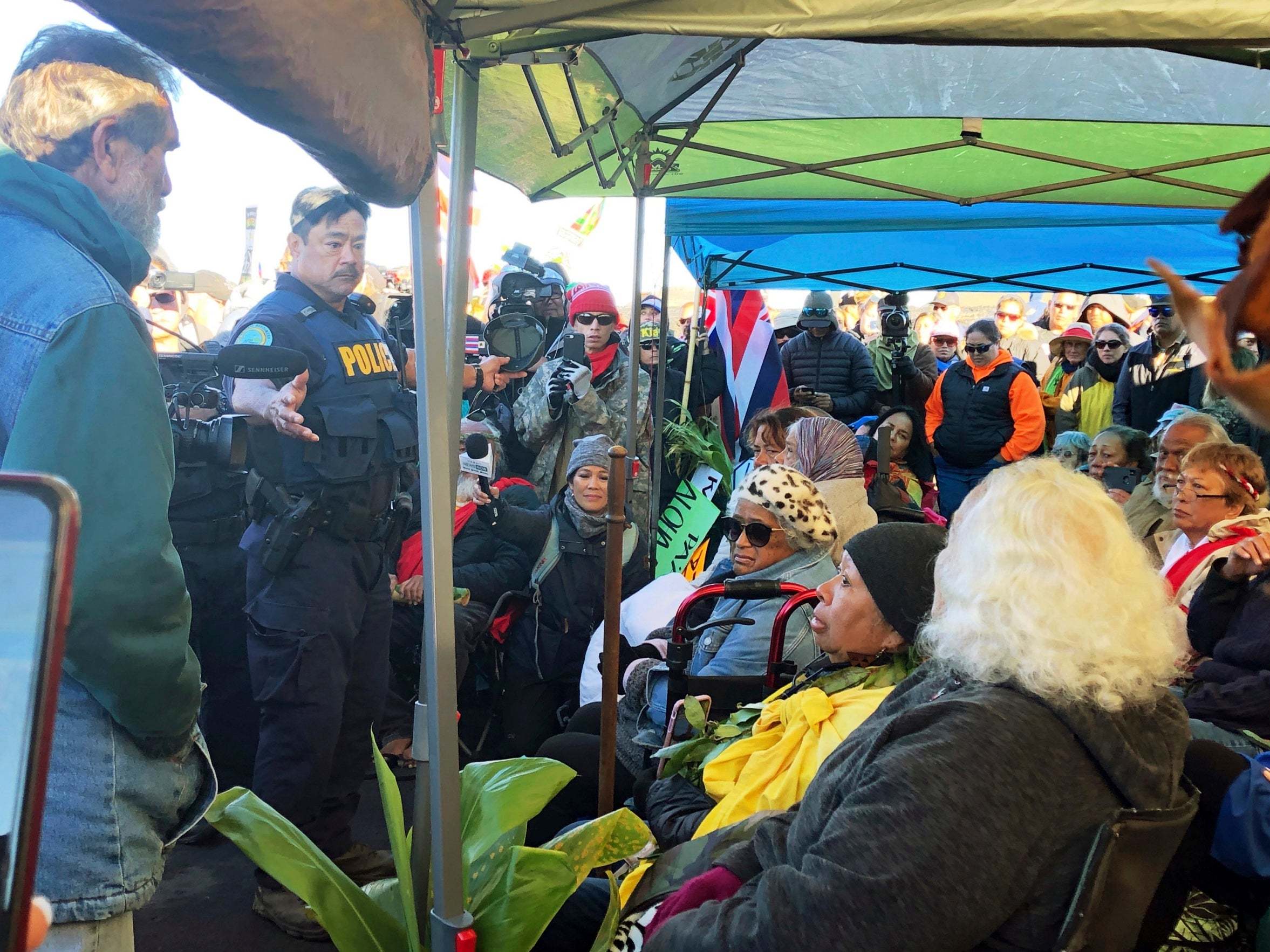 Officers from the Hawaii Department of Land and Natural Resources prepare to arrest protesters blocking road to giant telescope