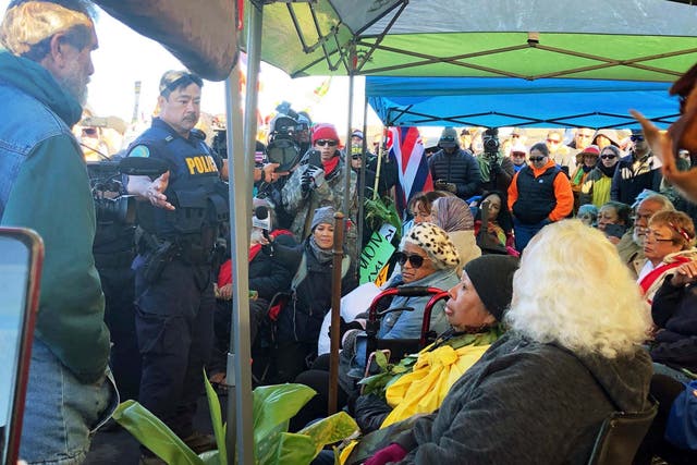 Officers from the Hawaii Department of Land and Natural Resources prepare to arrest protesters blocking road to giant telescope