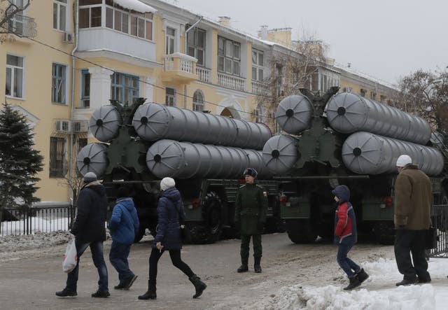 People walk past Russian S-400 missile air defence systems before a military parade in Volgograd in 2018