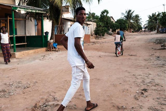 "Ayao", 15, a tramadol addict, walks around his neighbourhood in Togo while high on the opiod and cannabis