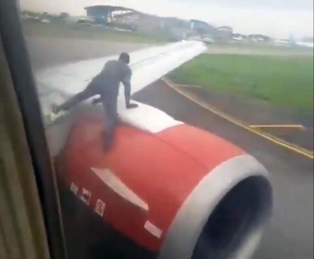 Man Climbs On To Wing Of Plane As It Is About To Take Off The