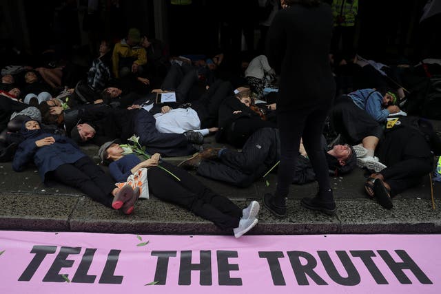 Members of Extinction Rebellion lay down on the floor as they protest outside Northcliffe House which contains the offices of the Daily Mail, Evening Standard and the Independent newspapers