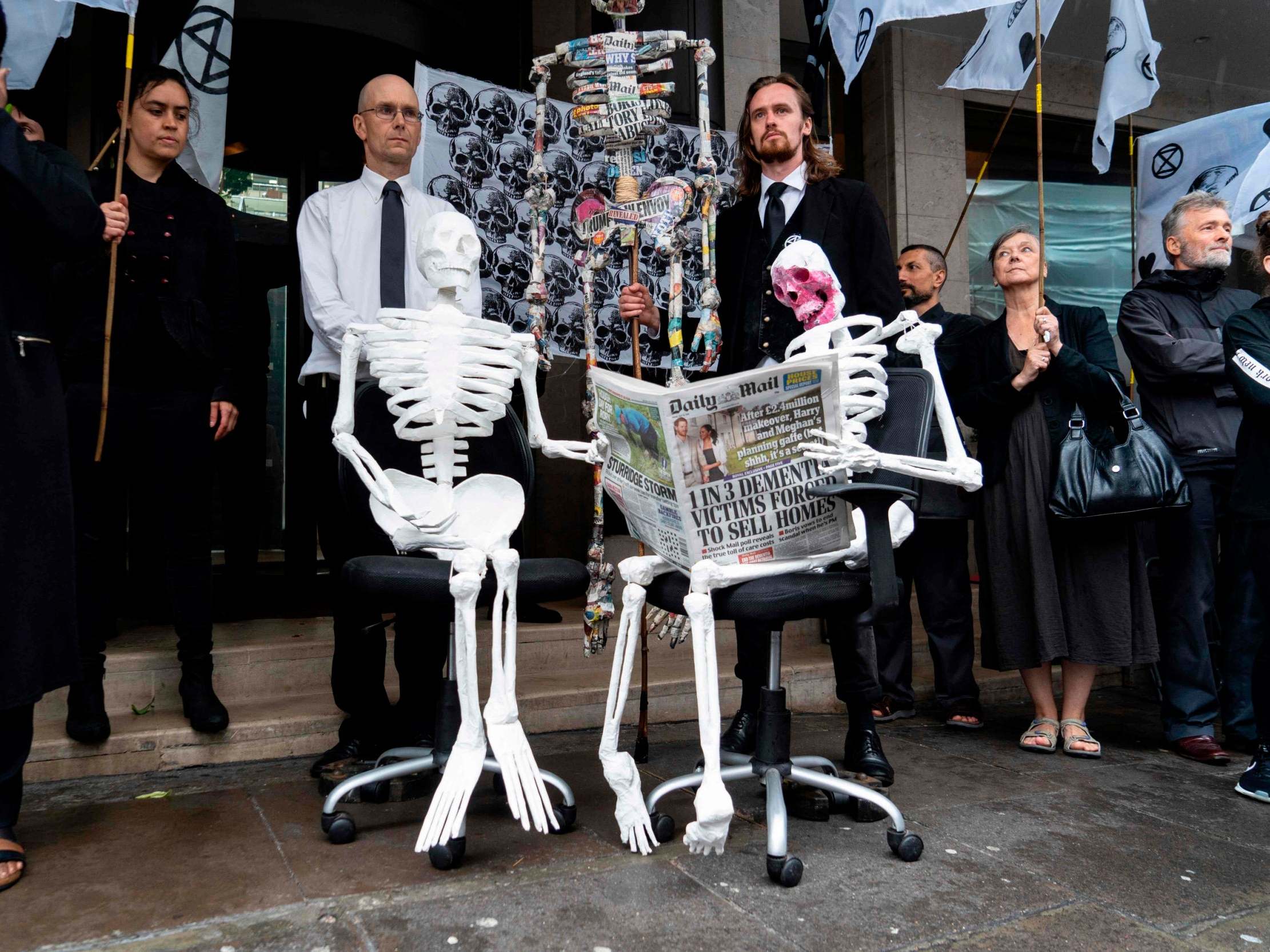 Demonstrators from the Extinction Rebellion climate environmental activist group take part in a protest outside the offices of UK newspapers including the Daily Mail at Northcliffe House in west London