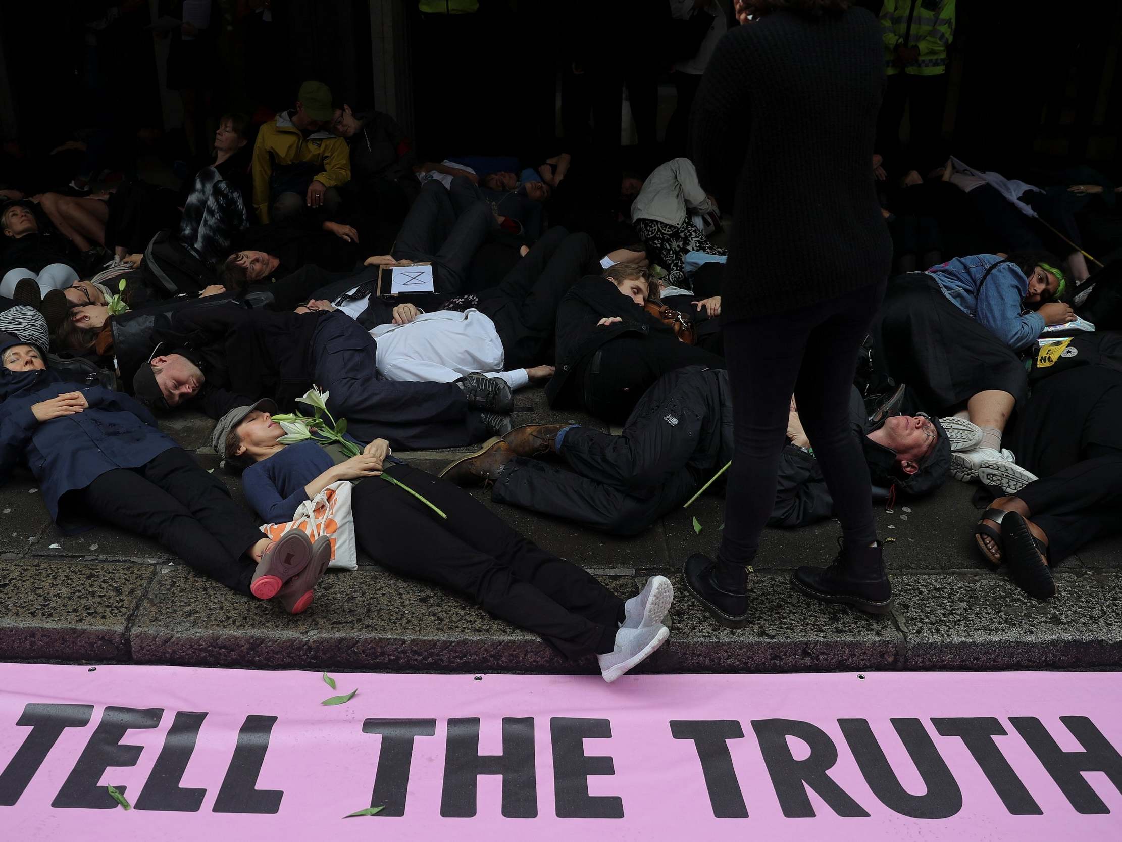 Members of Extinction Rebellion lay down on the floor as they protest outside Northcliffe House which contains the offices of the Daily Mail, Evening Standard and the Independent newspapers