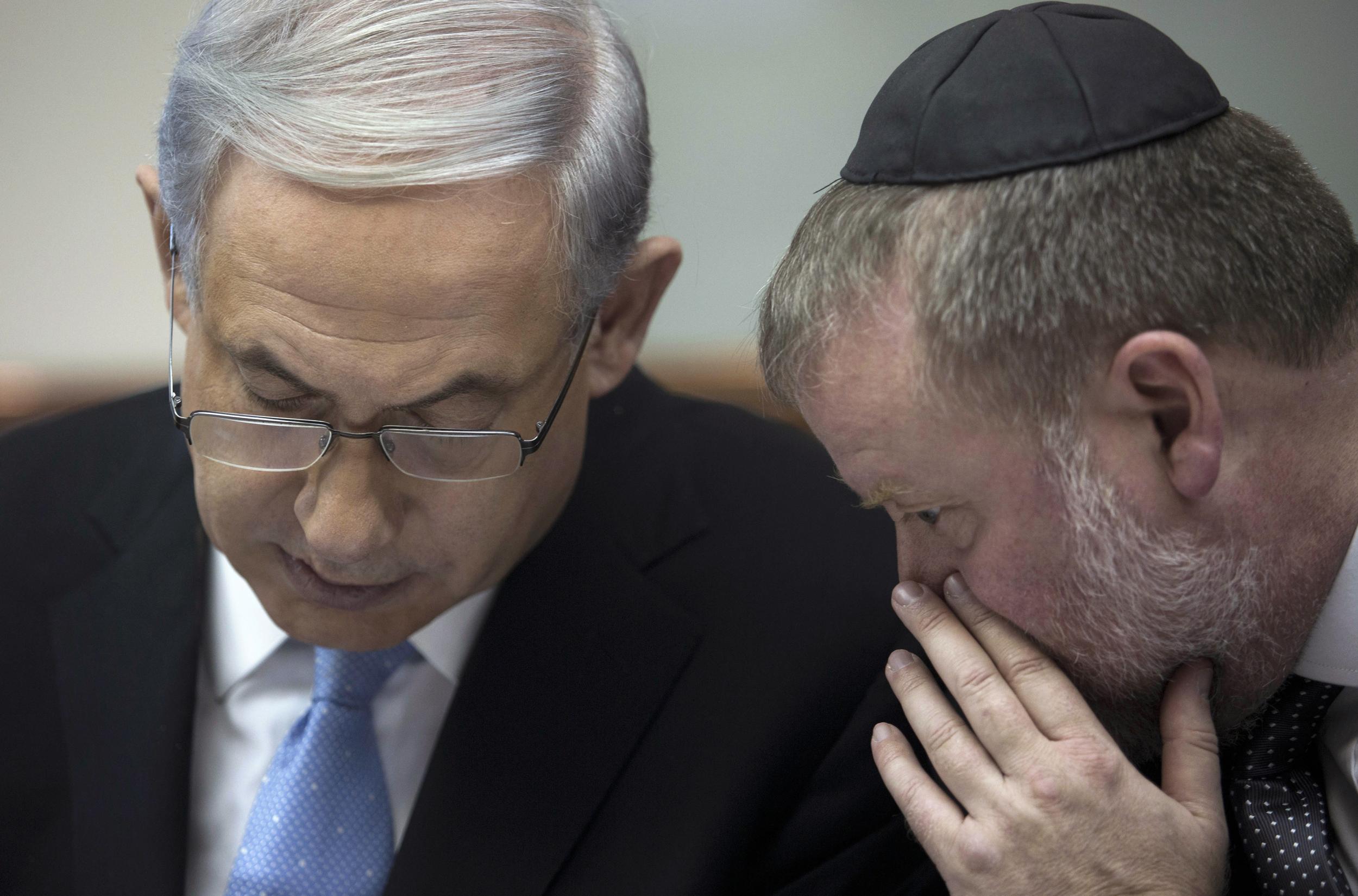 Mr Netanyahu listens to then cabinet secretary Avichai Mandelblit during the weekly cabinet meeting. Mr Mandelblit would go on to be the attorney general who will decide whether to indict his former colleague (Reuters)
