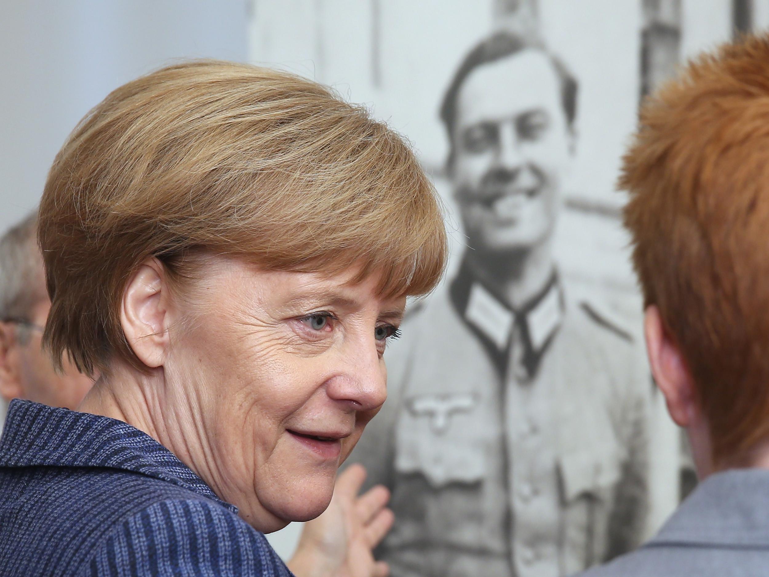 Angela Merkel in front of a photograph of Claus von Stauffenberg, the leader of the 20 July coup
