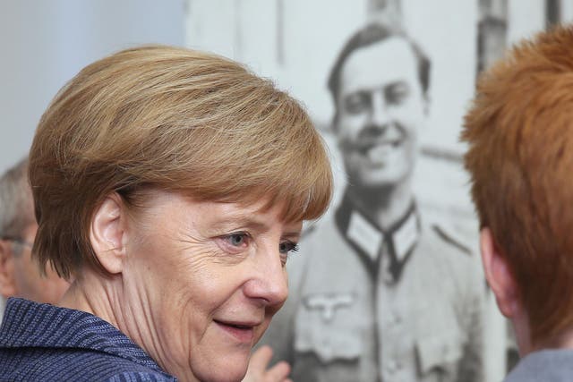 Angela Merkel in front of a photograph of Claus von Stauffenberg, the leader of the 20 July coup