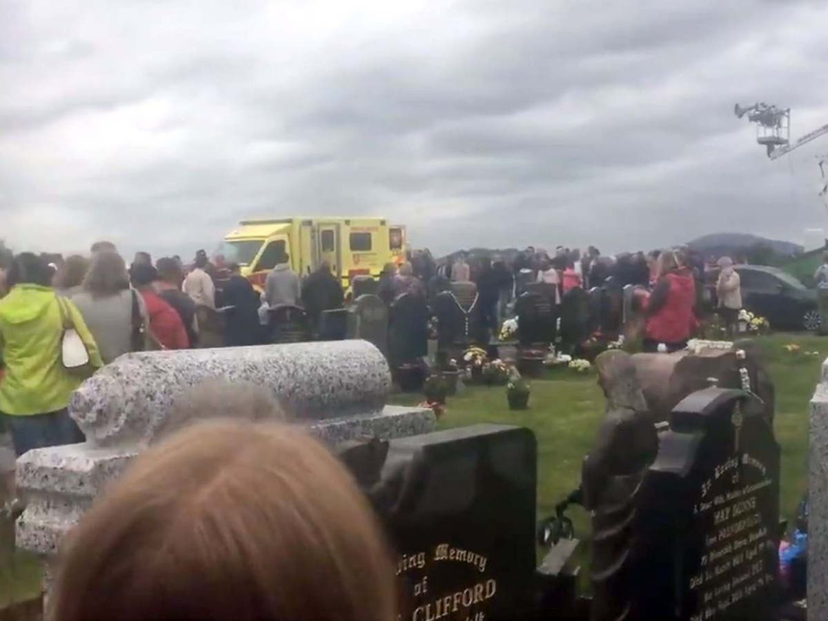 Driver arrested after car speeds into crowds at cemetery, leaving grandfather seriously injured