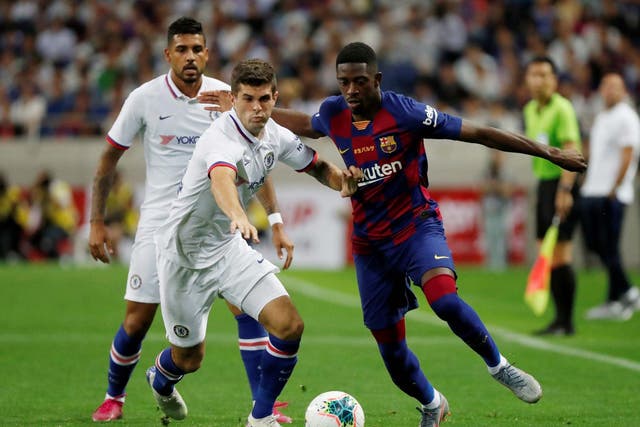 Barcelona's Ousmane Dembele in action with Chelsea's Christian Pulisic and Emerson Palmieri
