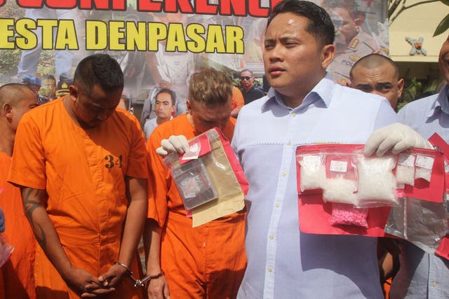 Australians William Cabantog (left) and David Van Iersel (centre) appear during a press conference in Denpasar, Bali, on 23 July 2019 after being arrested for alleged cocaine possession.