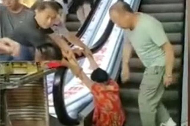 Shopper trapped in escalator at mall in Harbin, China