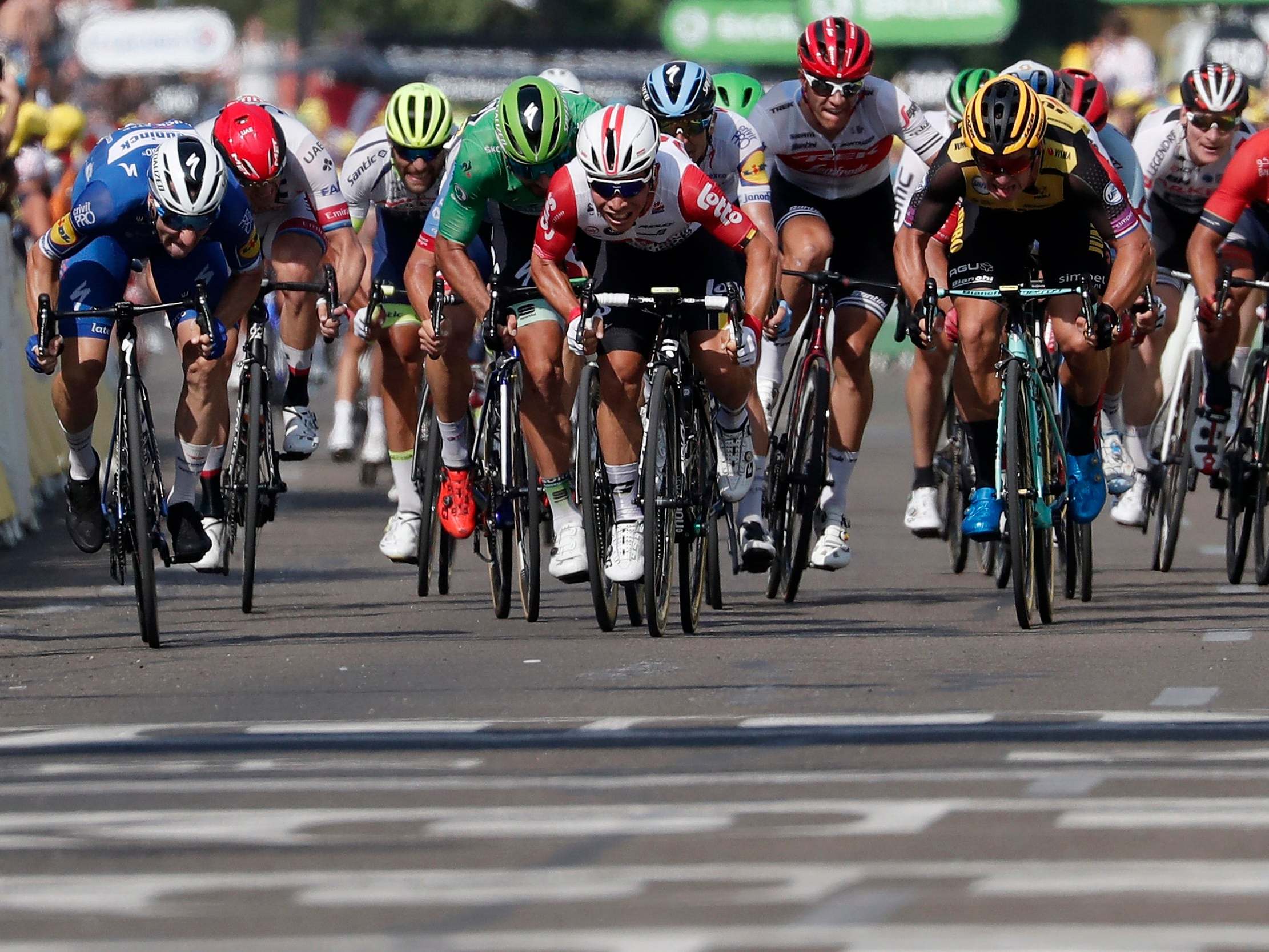 Caleb Ewan, centre, speeds to victory on stage 16 in Nimes