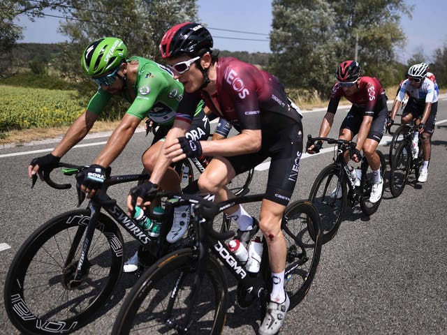 Geraint Thomas, right, bares the injury to his knee after crashing