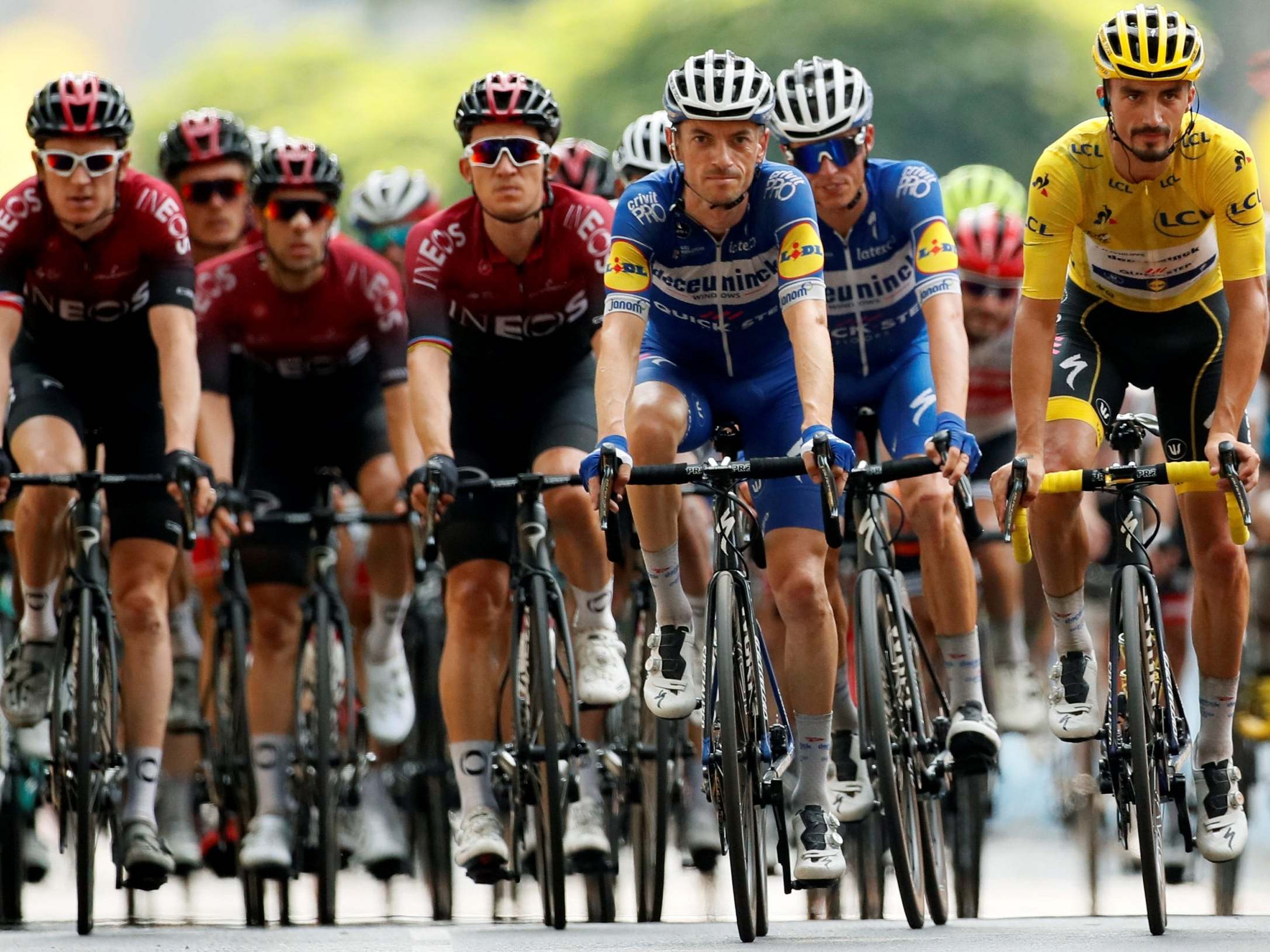 Julian Alaphilippe leads the main bunch across the finish line