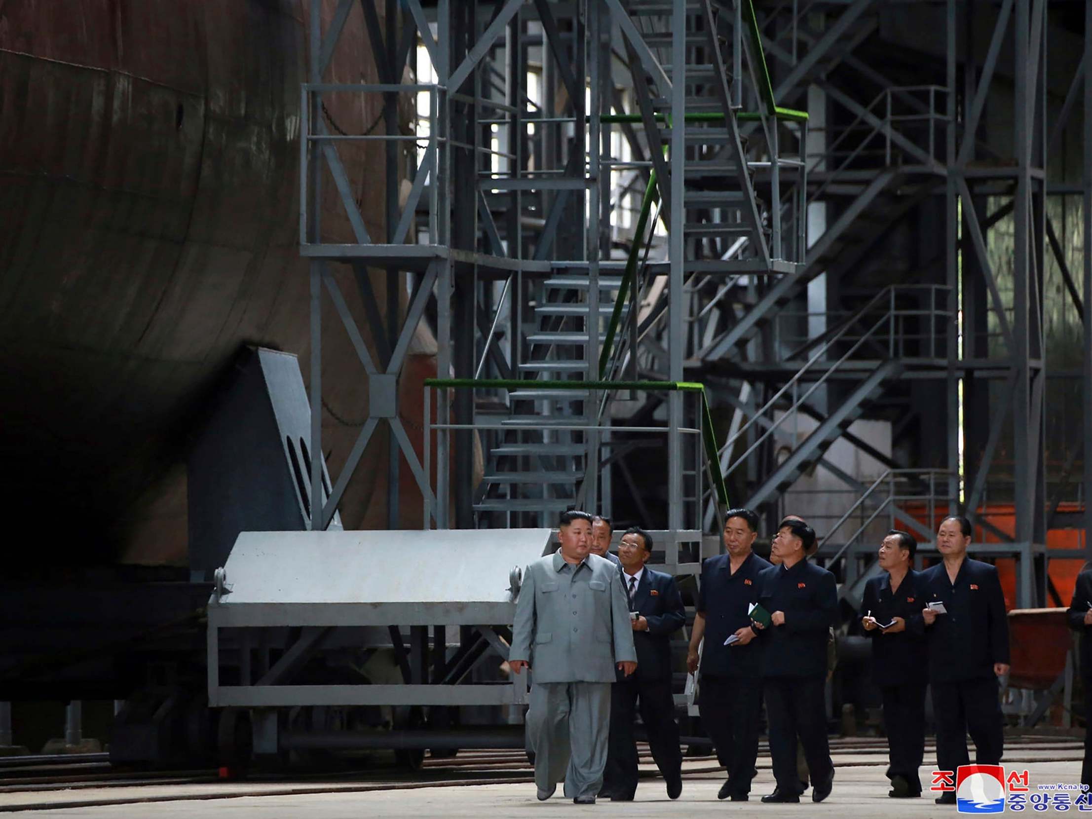 Kim Jong-un inspects a newly built submarine to be deployed at an unknown location in North Korea