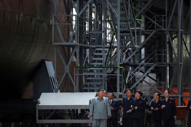 Kim Jong-un inspects a newly built submarine to be deployed at an unknown location in North Korea
