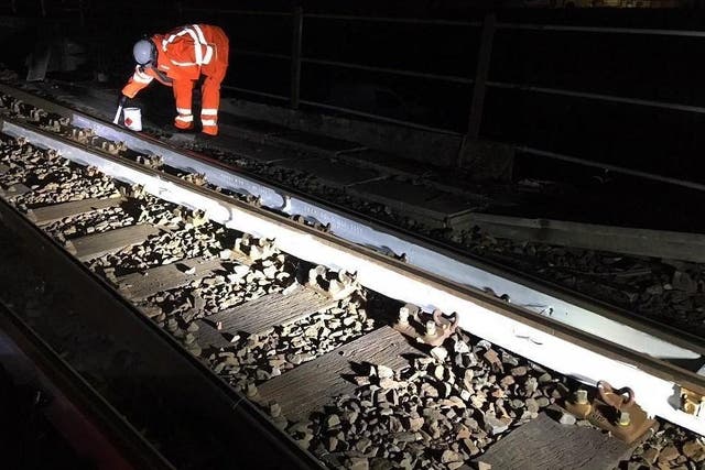 White hot: a member of Network Rail painting parts of the railway white to absorb less heat