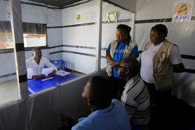 Claude Mabowa Sasi, 21, who had lost his mother, a brother and a sister to Ebola, takes his college-entry exam in quarantine as he recovers from the deadly disease himself