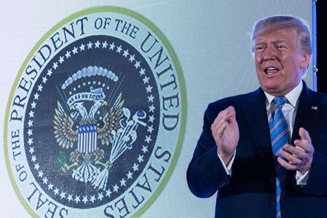 Donald Trump with doctored seal at Turning Point USA event