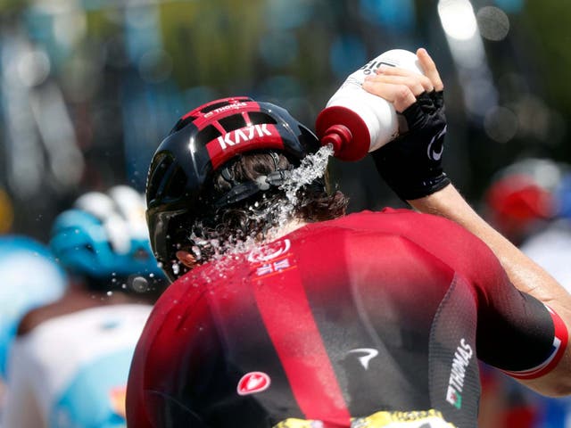 Britain's Geraint Thomas pours water onto his neck