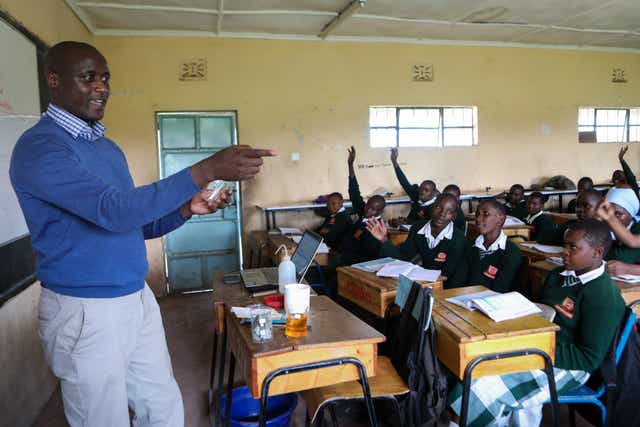 Teacher Peter Tabichi with his students during a physics lesson at Keriko Mixed Day Secondary School in Njoro, Nakuru County, Kenya