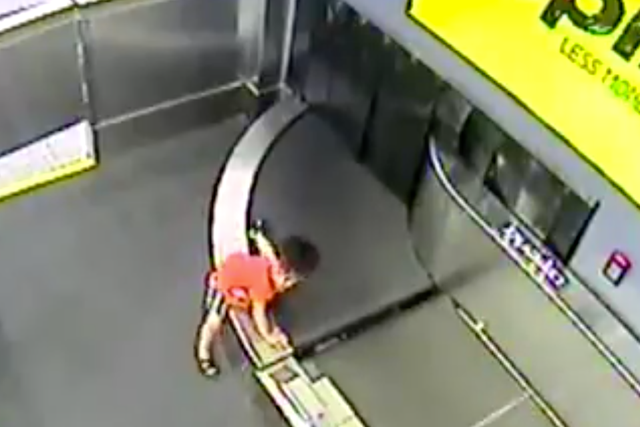 The moment the boy boards the conveyor belt