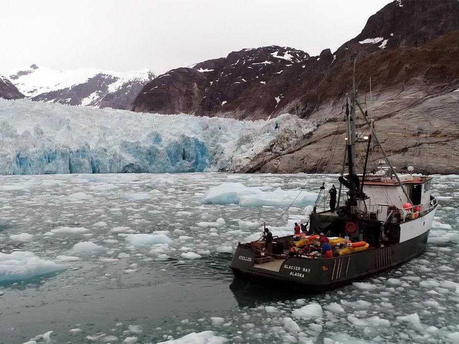 Researchers at Alaska's LeConte Glacier in 2016. A pole holds the sonar instrument that collects data on the subsurface ice