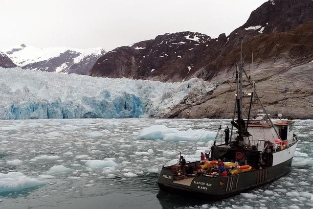 Researchers at Alaska's LeConte Glacier in 2016. A pole holds the sonar instrument that collects data on the subsurface ice 