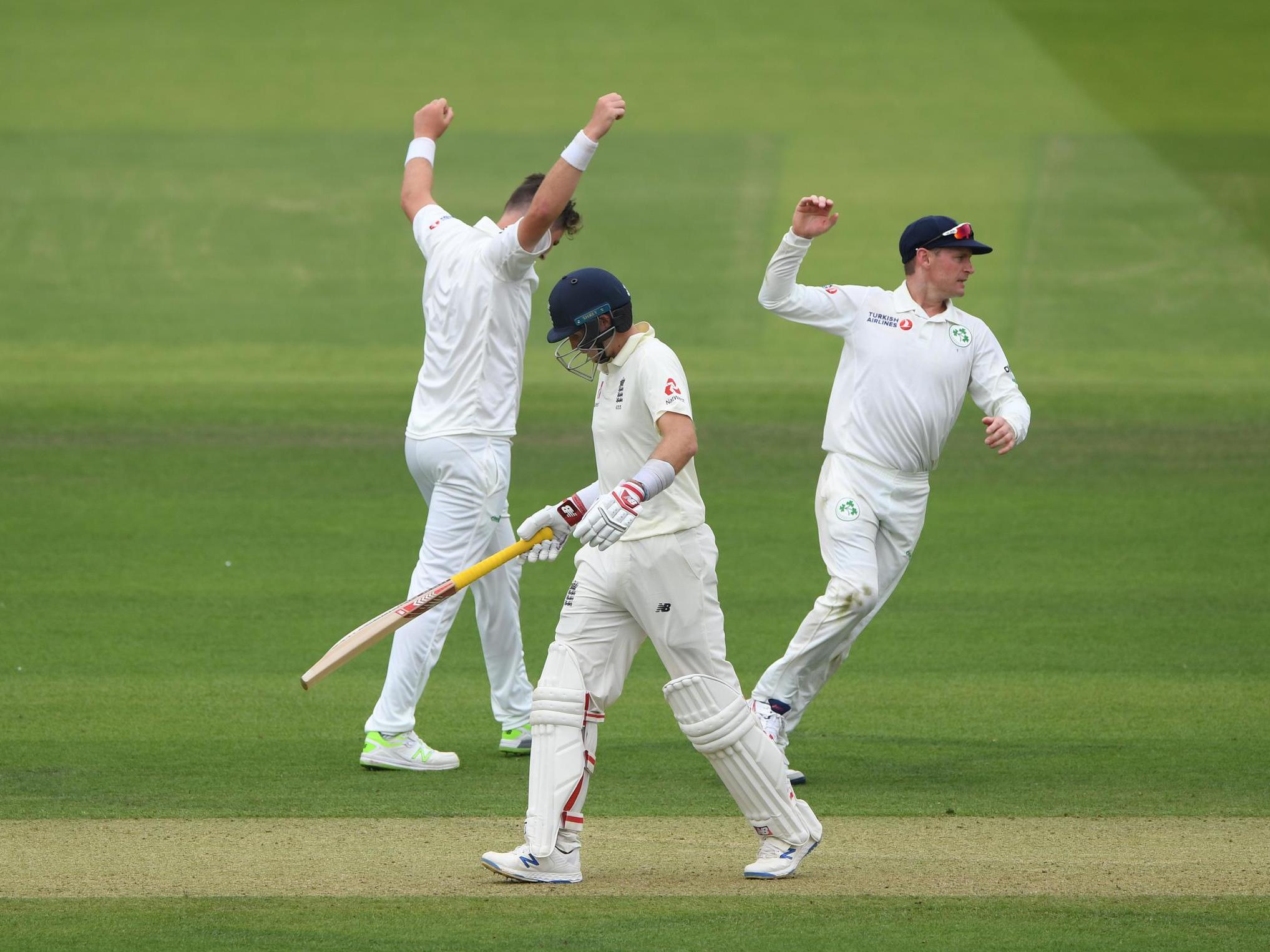 Mark Adair celebrates with captain William Porterfield after dismissing Joe Root