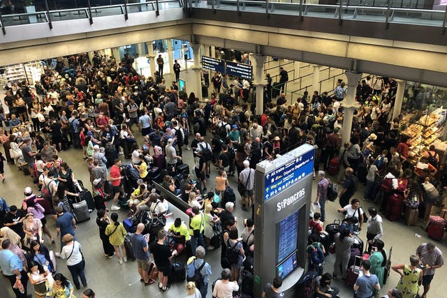 Crowd control: Police are in attendance as Eurostar passengers from cancelled trains try to rebook