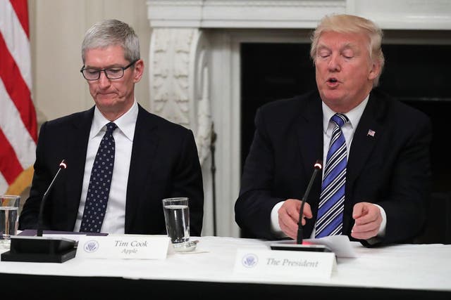 Donald Trump and Tim Cook sit as part of the president's American Technology Council in June 2017