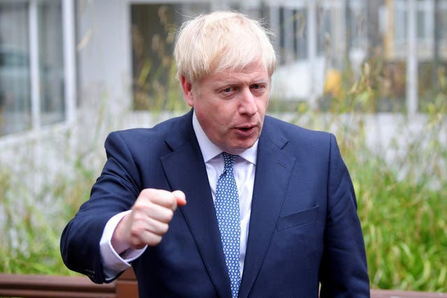 Boris Johnson gestures as he speaks during his visit to Birmingham