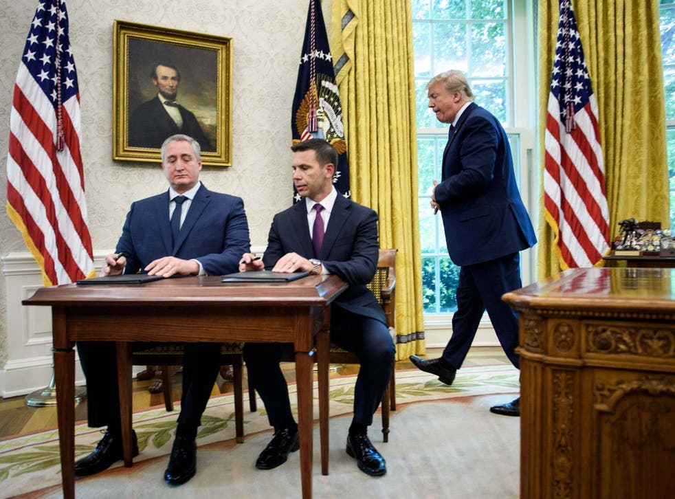 Donald Trump watches as Guatemala's interior minister and the acting US secretary of Homeland Security sign deal