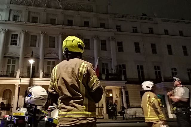 Firefighters and police outside the Bahrain embassy in London’s Belgrave Square as a man protests on the roof on 26 July