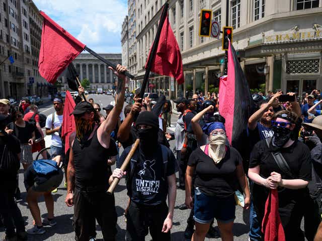Members of an anti-fascist or Antifa group march as the Alt-Right movement gathers for a "Demand Free Speech" rally