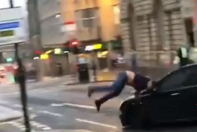 Still image taken from video shared on Facebook of a car appearing to drive at a man, knocking him to the ground in Newcastle city centre on 27 July 2019.