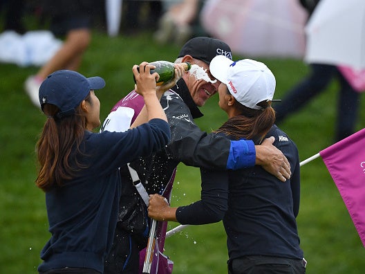 Ko and her caddie celebrate on the 18th green