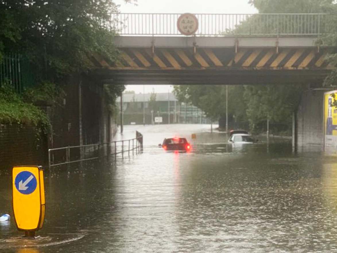 Vehicles stuck in several feet of water after flooding in Stockport, Manchester
